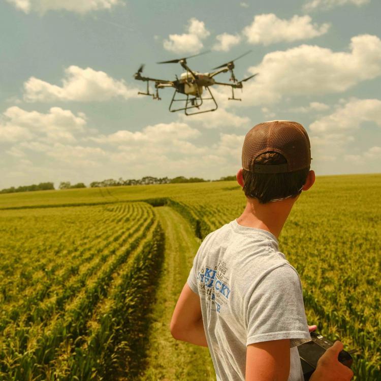  Boy Flying Drone Over Field